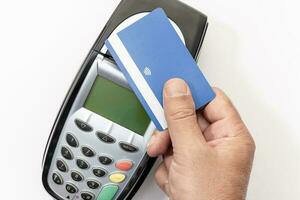 Hand make payment with credit card with NFC contactless technology on terminal device. White background photo