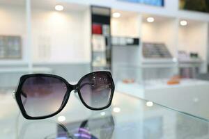 Black sunglass on table in optical shop photo