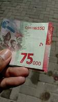 Indonesian currency worth 75 thousand rupiah. photo