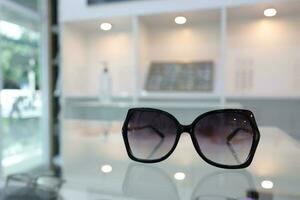 Black sunglass on table in optical shop photo