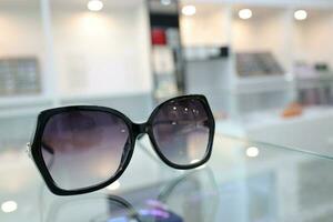 Black sunglass on table in optical shop photo