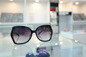 Black sunglass on table in optical shop photo