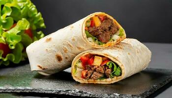Burritos wraps with beef and vegetables on black background. Beef burrito, mexican food. photo