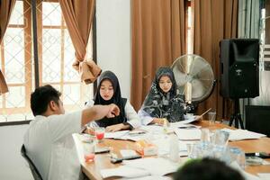 Kuaro Kalimantan timur, Indonesia 6 July 2023. some people are working on making documents in the office photo