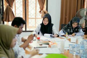 Kuaro Kalimantan timur, Indonesia 6 July 2023. some people are working on making documents in the office photo