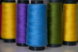 Some multicolor Spools of  swings thread Close-up Focus photo