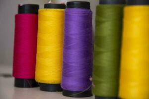 Some multicolor Spools of  swings thread Close-up Focus photo