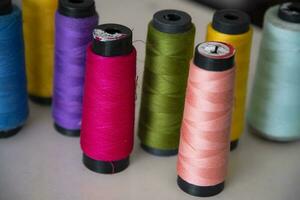 Some multicolor Spools of  swings thread Close-up Focus photo