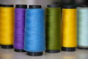 Some multicolor Spools of  swings thread Close-up Focus photo