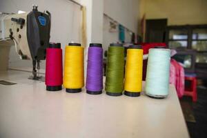 Some multicolor Spools of  swings thread Close-up Focus photo