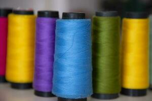 Some multicolor Spools of  swings thread Close-up Focus photo