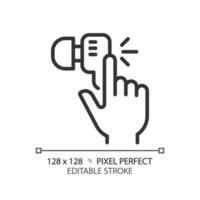 Hand with earphone pixel perfect linear icon. Finger tapping key on audio device. Wireless gadget for music listening. Thin line illustration. Contour symbol. Vector outline drawing. Editable stroke