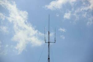 Lightning rod tower with blue sky background photo