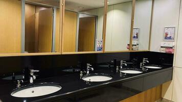 Restroom, toilet room. Washbasins, washstands. Toilet cubicles in an office building. photo