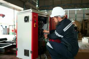 Electrical engineer with the mission of installing a robot arm electrical system photo