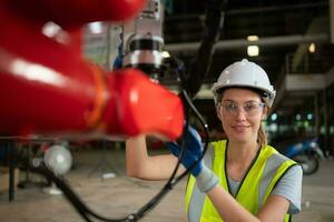 An engineers installing and testing a large robotic arm. before sending it to customers for use in the industry photo