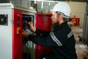 Electrical engineer with the mission of installing a robot arm electrical system photo