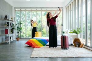 A homestay in the countryside, a natural attraction Welcome LGBT couples by cover a rainbow flag on the mattress in a bedroom overlooking natural beauty. have to take a selfie to show friends. photo