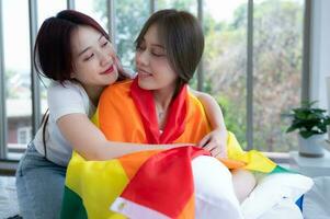 On the day of the couple's trip, the LGBT couples use the rainbow flag to cover their partner on the bed in the hotel room. photo