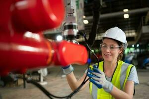 An engineers installing and testing a large robotic arm. before sending it to customers for use in the industry photo