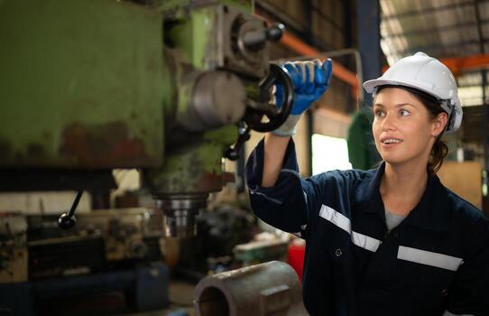 Portrait of mechanical engineers are checking the working condition of an old machine that has been used for some time. In a factory where natural light shines onto the workplace photo