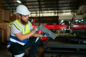 A mechanical engineer measuring product dimensions of new machinery installed photo