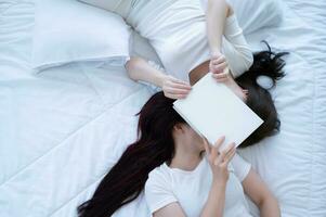 On white bed, LGBT couple kissing photo