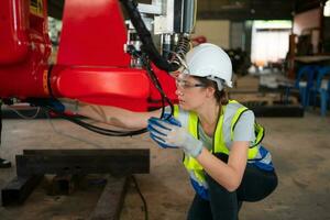 An engineers installing and testing a large robotic arm. before sending it to customers for use in the industry photo