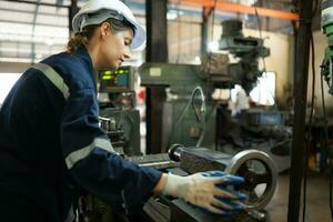 Portrait of mechanical engineers are checking the working condition of an old machine that has been used for some time. In a factory where natural light shines onto the workplace photo