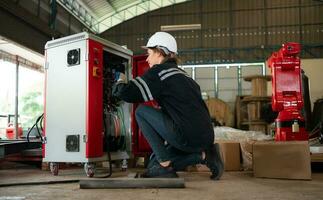 Electrical engineer with the mission of installing a robot arm electrical system photo