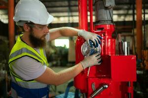 Mechanical engineers are checking the working condition of the new machine after completing the installation photo