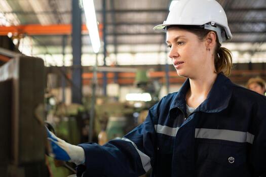 Portrait of mechanical engineers are checking the working condition of an old machine that has been used for some time. In a factory where natural light shines onto the workplace photo