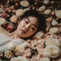 portrait of a woman lying among flowers photo