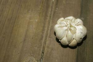 fresh garlic on a wooden table photo