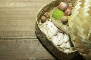 The vegetables ingredients for cooking on the woven bamboo. herbs photography. suitable for kitchen background image photo