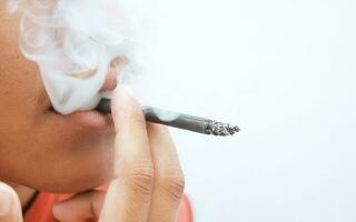 A person smoking on a white background photo