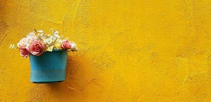 Beautiful white, pink and red rose bouquet blooming in blue flower pot or vase hanging or isolated on rough yellow wall background with right copy space. photo