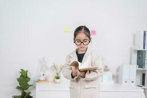 Little business lady Asia. formalwear sitting at the table and holding a notebook photo