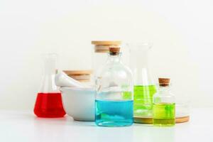 some test tube on the white table with beakers, flasks, and test tubes filled with colorful liquids photo