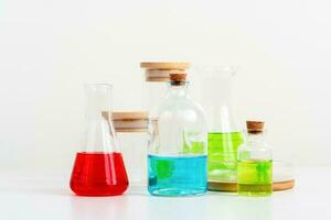 some test tube on the white table with beakers, flasks, and test tubes filled with colorful liquids photo