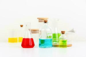 some test tube on the white table with beakers, flasks, and test tubes filled with colorful liquids photo