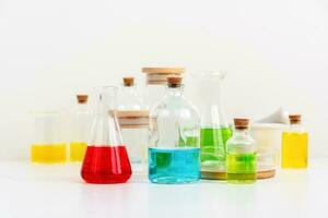some test tube on the white table with beakers, flasks, and test tubes filled with colorful liquids photo