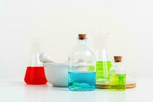 some test tube on the white table with beakers, flasks, and test tubes filled with colorful liquids photo