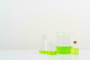 some test tube on the white table  with beakers, flasks, and test tubes filled with colorful liquids photo