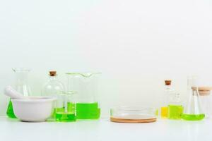 some test tube on the white table with beakers, flasks, and test tubes filled with colorful liquids photo