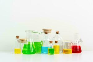 some test tube on the white table with beakers, flasks, and test tubes filled with colorful liquids photo