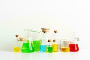 some test tube on the white table with beakers, flasks, and test tubes filled with colorful liquids photo