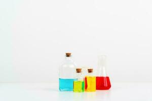 some test tube on the white table with beakers, flasks, and test tubes filled with colorful liquids photo