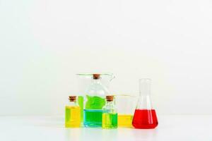 some test tube on the white table with beakers, flasks, and test tubes filled with colorful liquids photo