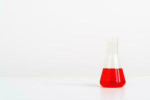 some test tube on the white table with beakers, flasks, and test tubes filled with colorful liquids photo